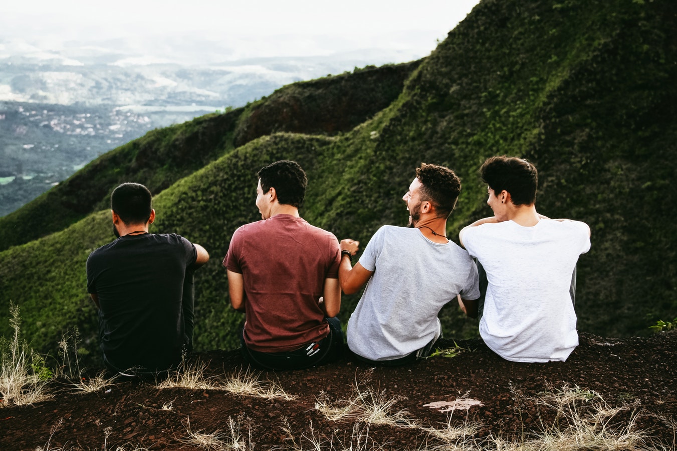 millennial men laughing on a hill side